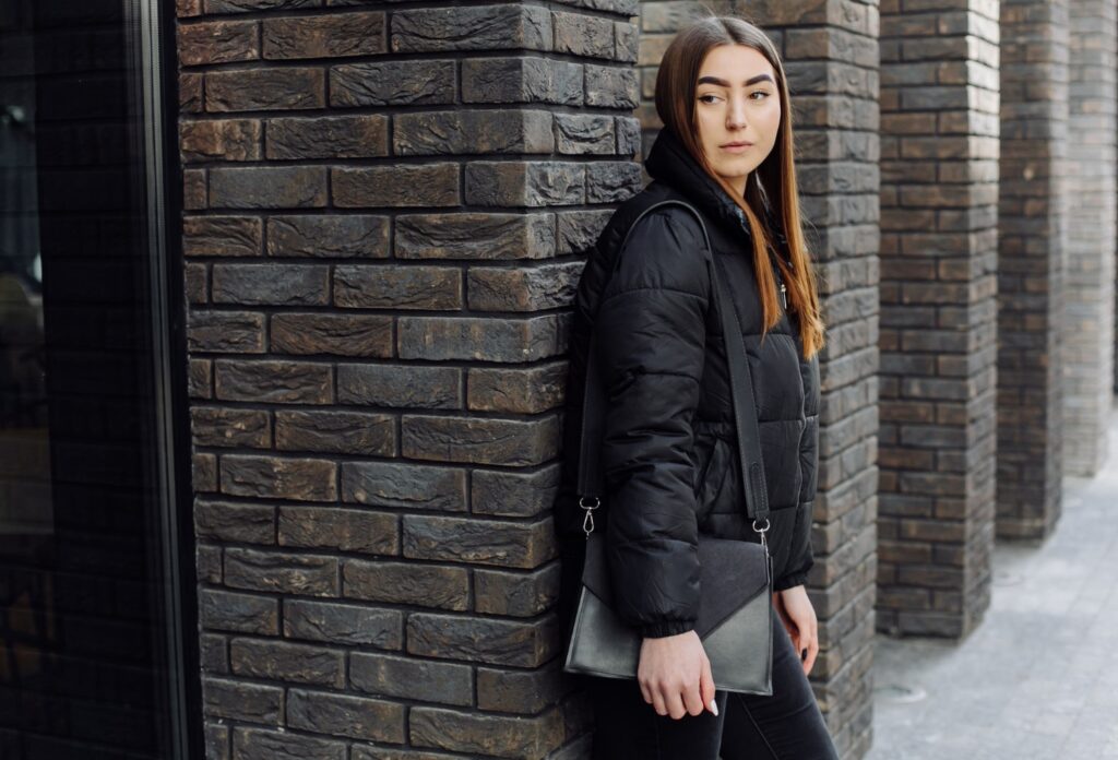 The New Everyday Chic: Mastering the Look of a Puffer Jacket, Crossbody Bag, and Little Black Dress